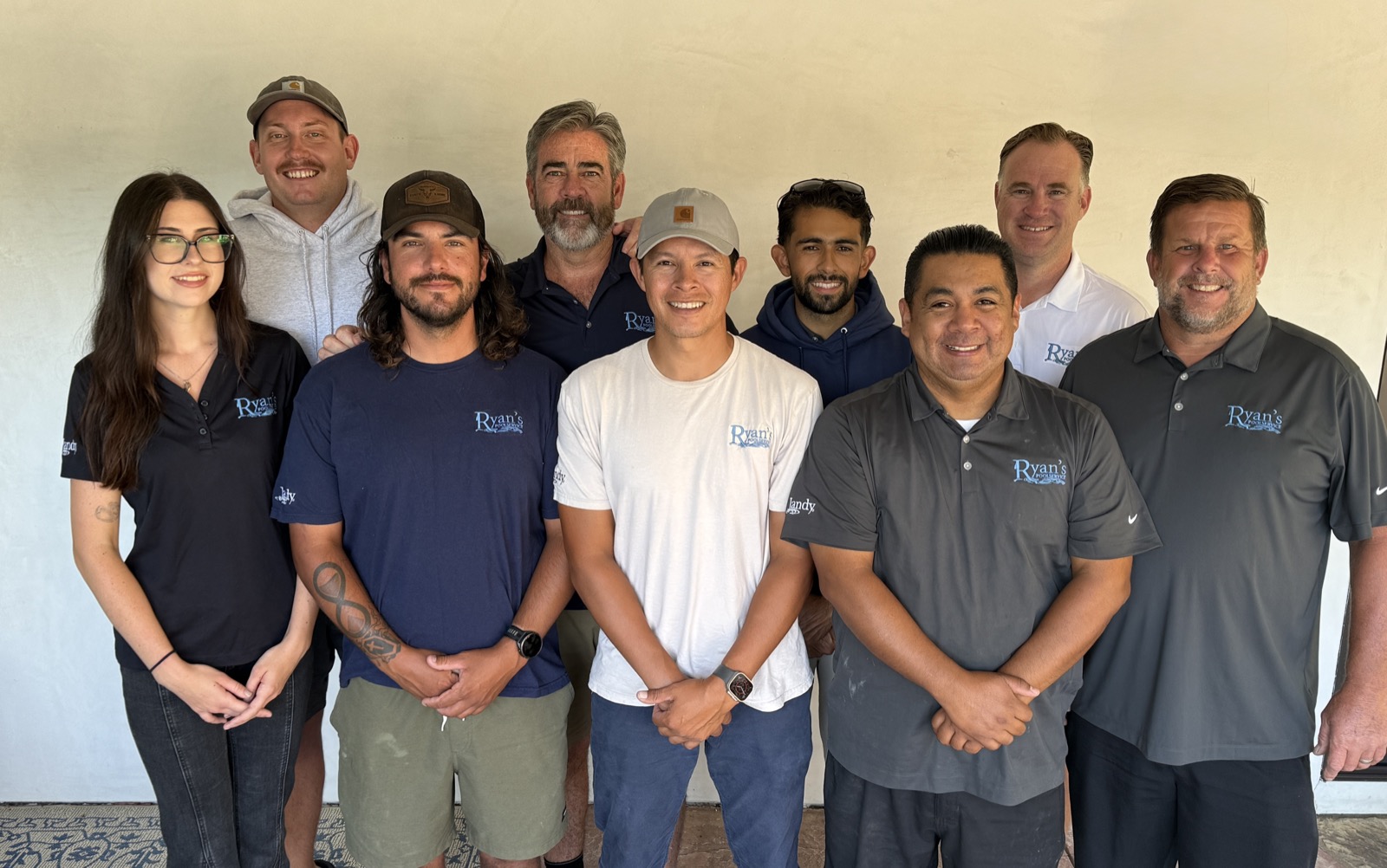 The Ryan’s Pool Service team together, wearing branded polos